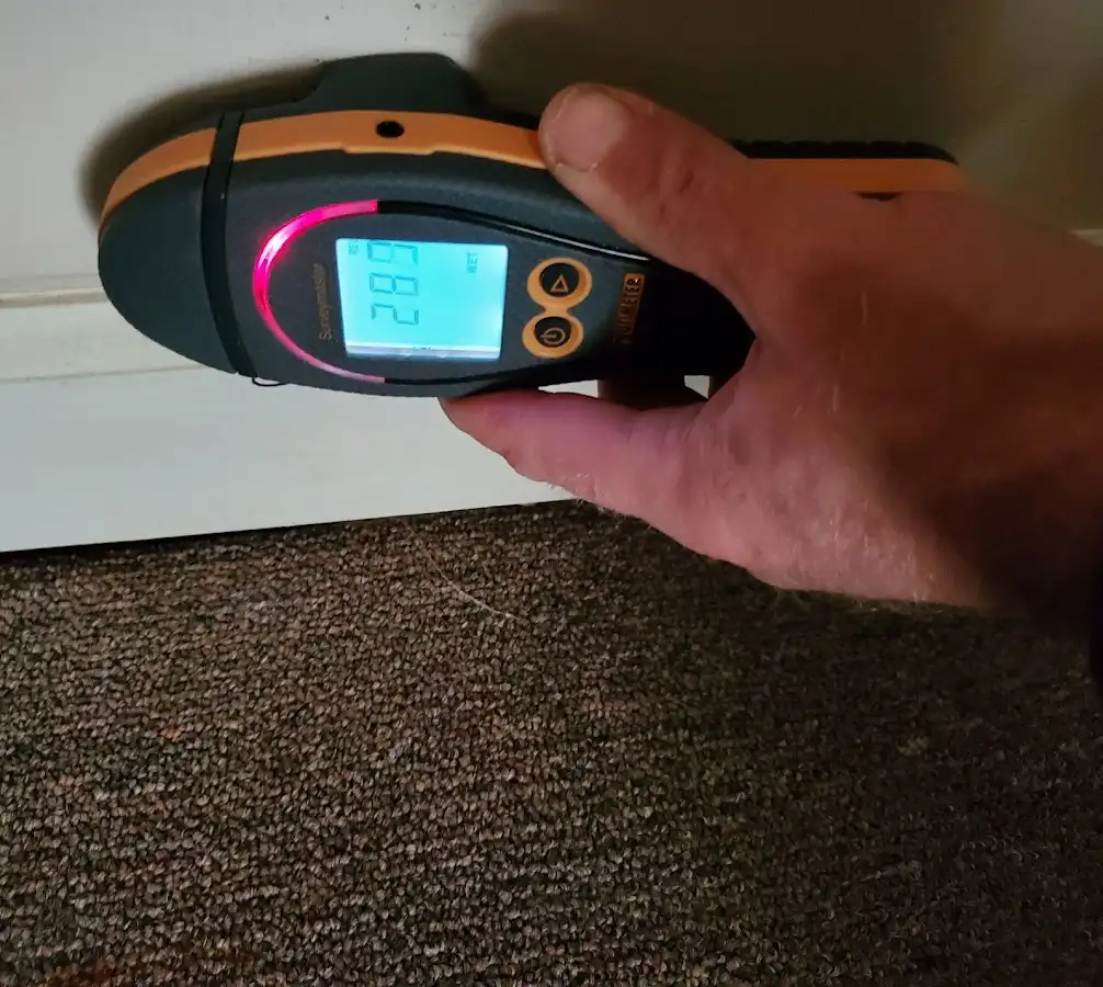 Moisture detection at baseboard during Storm Damage Restoration in Surfside